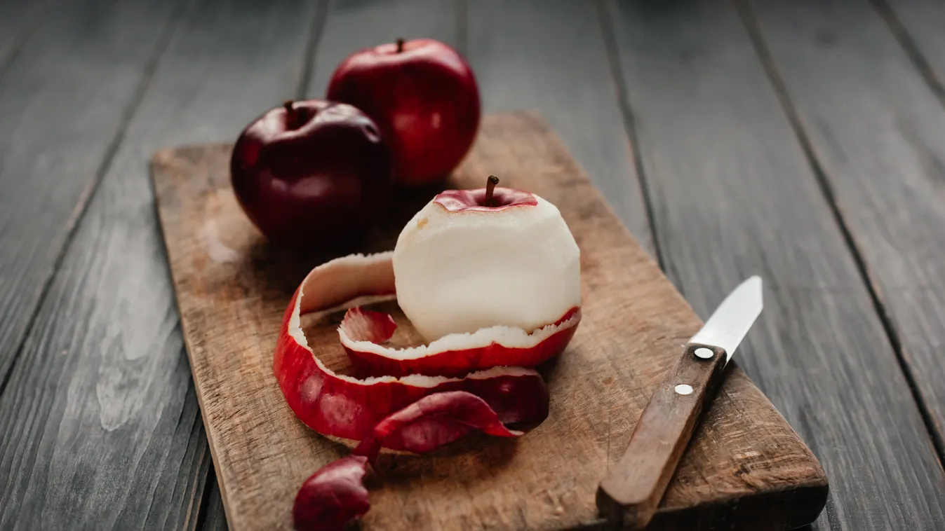 Peel and sliced apples on a kitchen board