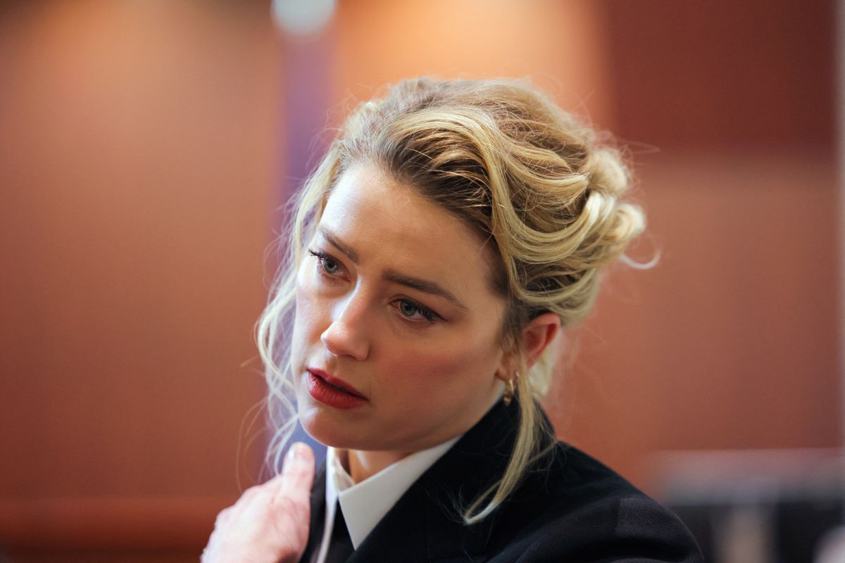 Actor Amber Heard looks on during Johnny Depp's defamation trial against her at the Fairfax County Circuit Courthouse in Fairfax, Virginia, on April 13, 2022. - Heard is being sued for defamation by her former husband, US actor Johnny Depp, after she wrote an op-ed in The Washington Post in 2018 that, without naming Depp, accused him of domestic abuse. (Photo by EVELYN HOCKSTEIN / POOL / AFP)