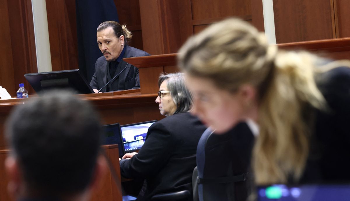 US actress Amber Heard (R) speaks to her legal team as US actor Johhny Depp (L) returns to the stand after a lunch recess during the 50 million US dollar Depp vs Heard defamation trial at the Fairfax County Circuit Court in Fairfax, Virginia, - Actor Johnny Depp is suing ex-wife Amber Heard for libel after she wrote an op-ed piece in The Washington Post in 2018 referring to herself as a “public figure representing domestic abuse.” (Photo by Jim LO SCALZO / POOL / AFP)