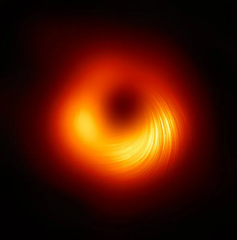 This handout photograph released by The European Southern Observatory on March 24, 2021, shows the polarised view of the black hole in the Messier 87 (M87) galaxy, with lines marking the orientation of polarisation, which is related to the magnetic field around the shadow of the black hole by The Event Horizon Telescope (EHT) collaboration. - The astronomers who gave the world it's first true glimpse of a black hole have produced another landmark image, this time capturing the polarised light swirling around the same star-eating monster's magnetic fields.
But it is more than just a pretty picture. Never before has it been possible to measure polarisation -- which causes light waves to vibrate in a single plane -- so close to the edge of a black hole.  The new observations, based on data collected by the Event Horizon Telescope (EHT) in 2017, are key to understanding how a galaxy can project streams of energy thousands of lightyears outward from its core, more than 300 scientists reported Wednesday in a pair of studies. (Photo by Handout / European Southern Observatory / AFP) / RESTRICTED TO EDITORIAL USE - MANDATORY CREDIT "AFP PHOTO /EUROPEAN SOUTHERN OBSERVATORY " - NO MARKETING - NO ADVERTISING CAMPAIGNS - DISTRIBUTED AS A SERVICE TO CLIENTS