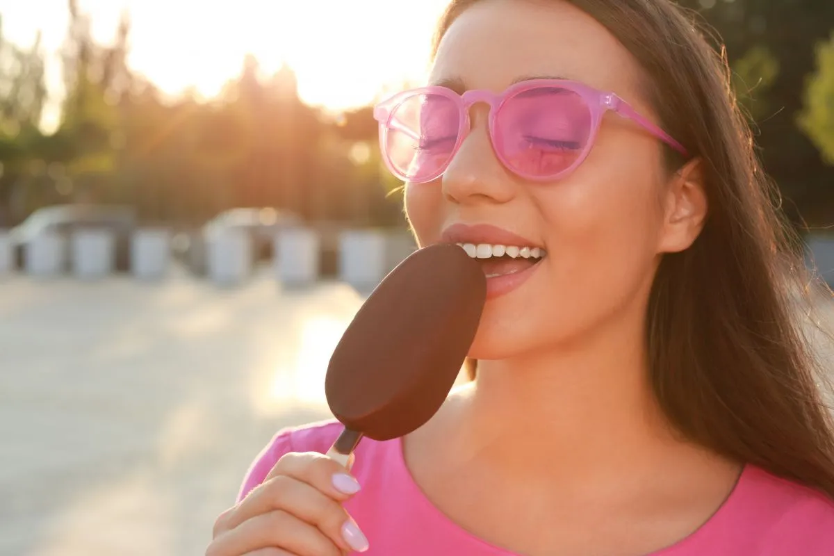 Beautiful,Young,Woman,Eating,Ice,Cream,Glazed,In,Chocolate,On
