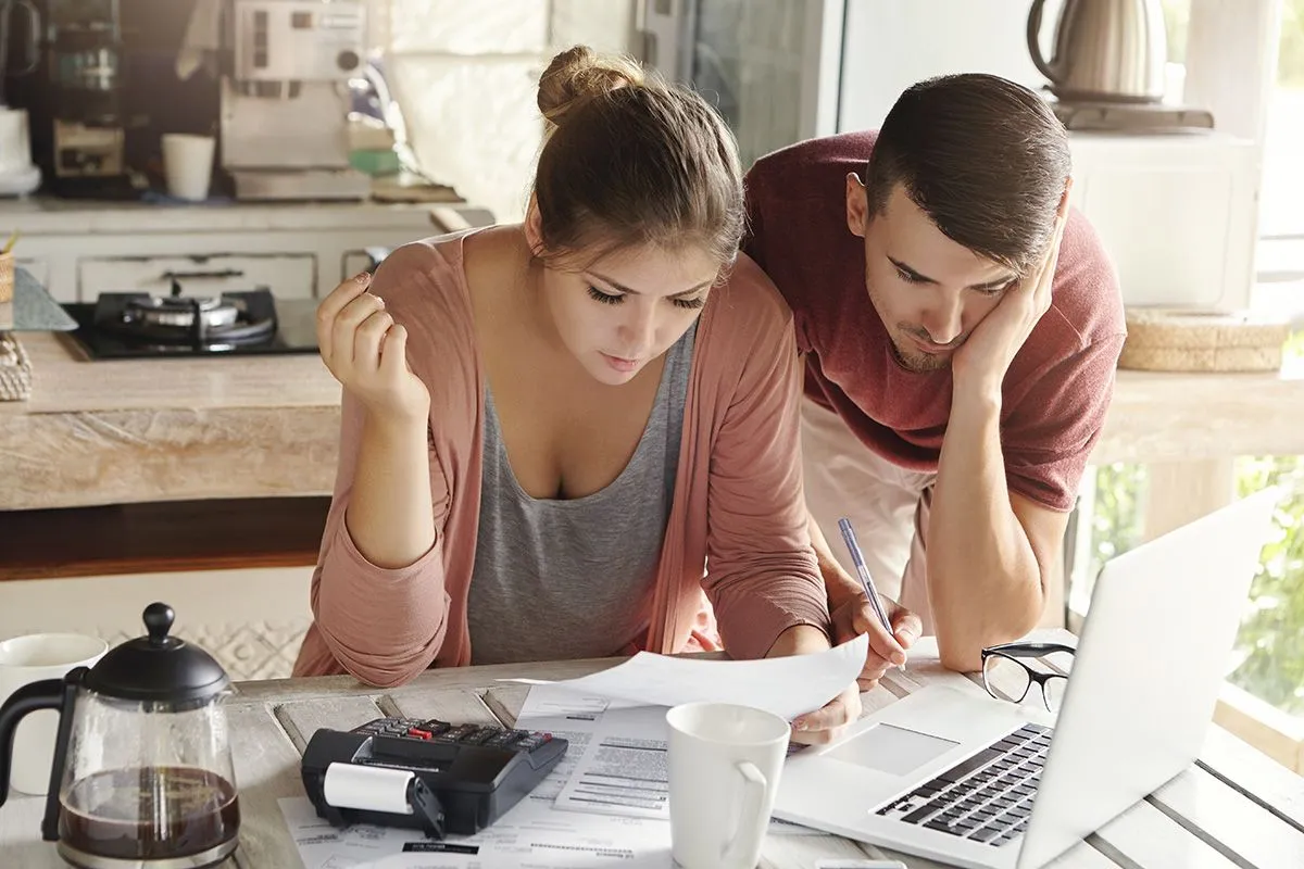 Young,Married,Couple,With,Many,Debts,Doing,Paperwork,Together,,Reviewing
