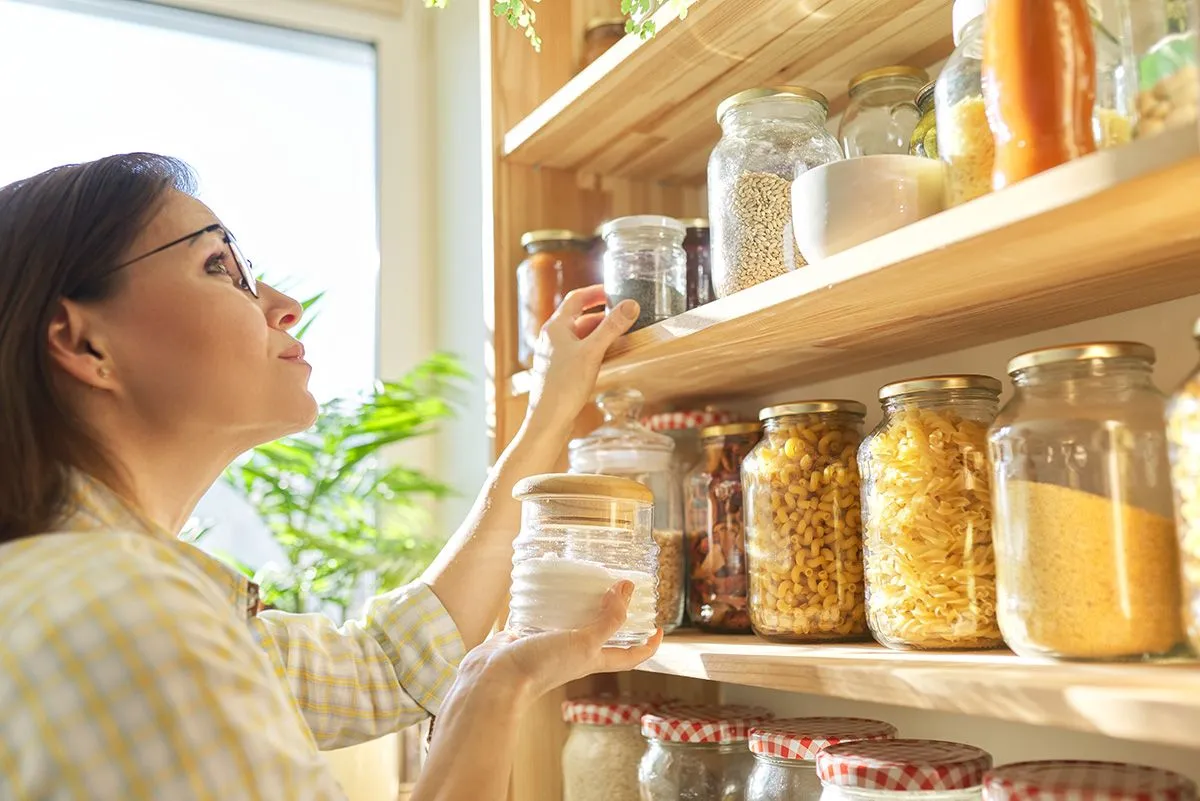 Food,Storage,In,Pantry,,Woman,Holding,Jar,Of,Sugar,In