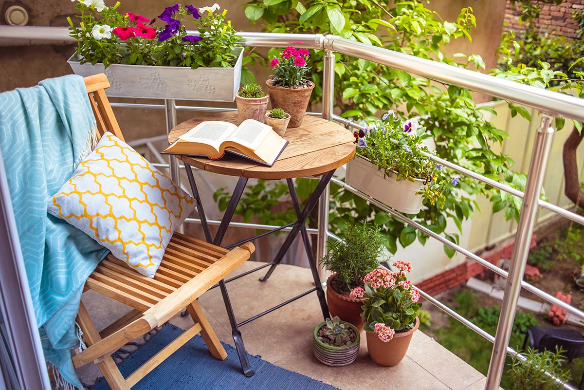 Beautiful,Terrace,Or,Balcony,With,Small,Table,,Chair,And,Flowers