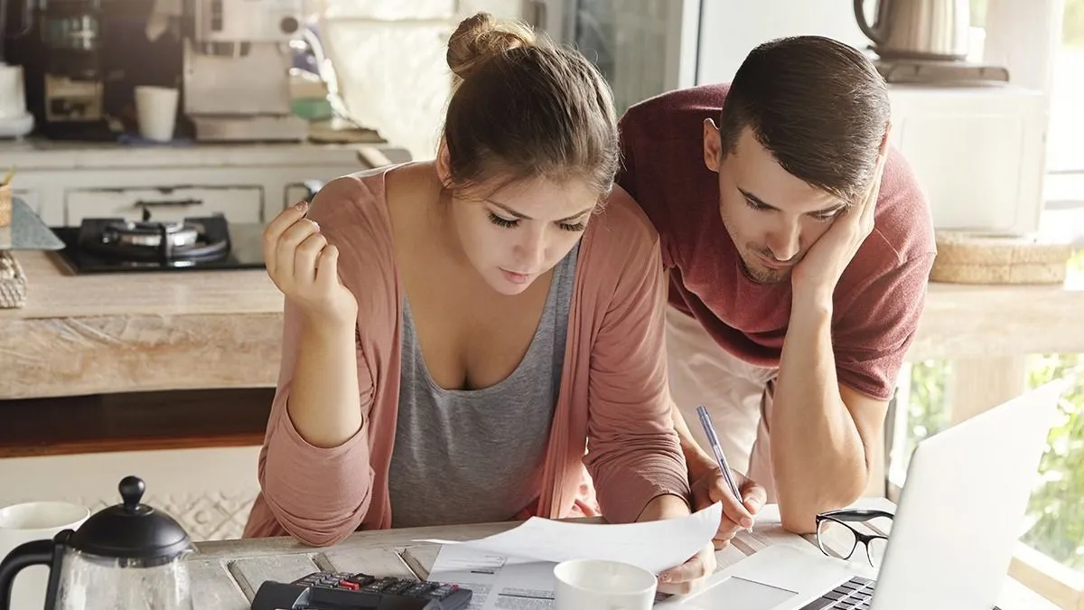 Young,Married,Couple,With,Many,Debts,Doing,Paperwork,Together,,Reviewing