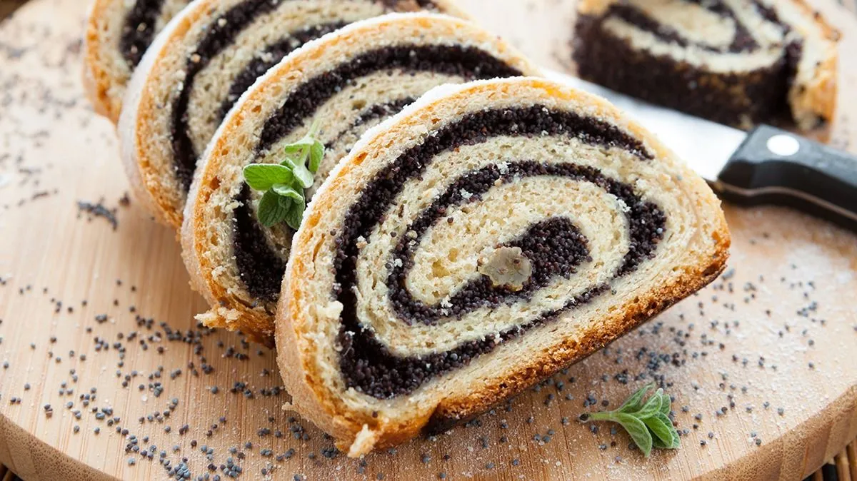 Poppy,Seed,Roll,On,A,Wooden,Surface,,Closeup