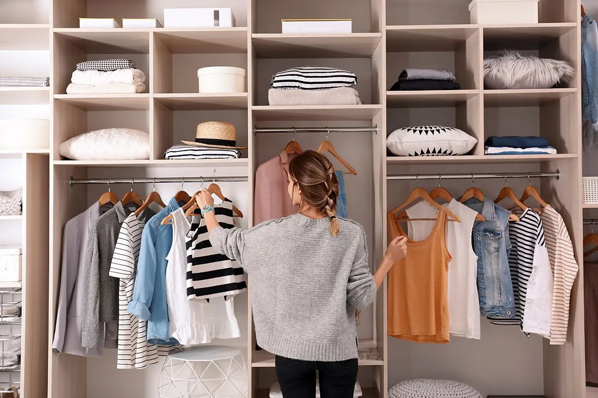 Woman,Choosing,Outfit,From,Large,Wardrobe,Closet,With,Stylish,Clothes