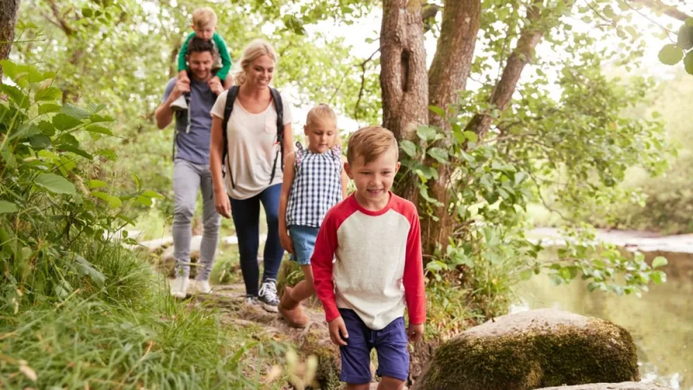 Family,Hiking,Along,Path,By,River,In,Uk,Lake,District