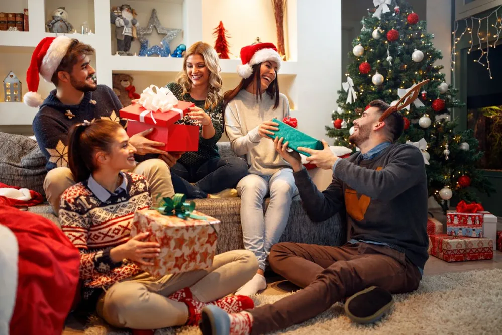 Group,Happy,Of,Friends,Laughing,And,Sharing,Christmas,Gifts