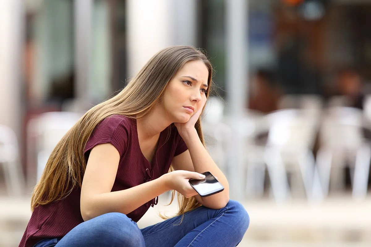 Sad,Girl,Waiting,For,A,Mobile,Phone,Call,Or,Message