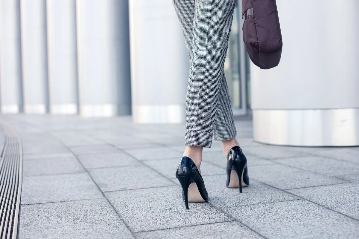 Close,Up,Of,Female,Legs,Of,Worker,Standing,Near,Her