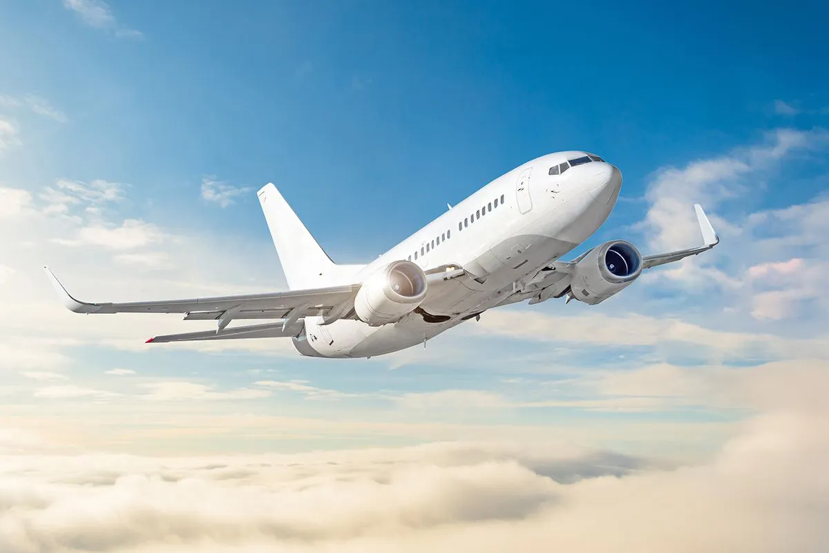 Passenger,Aircraft,Cloudscape,With,White,Airplane,Is,Flying,In,The