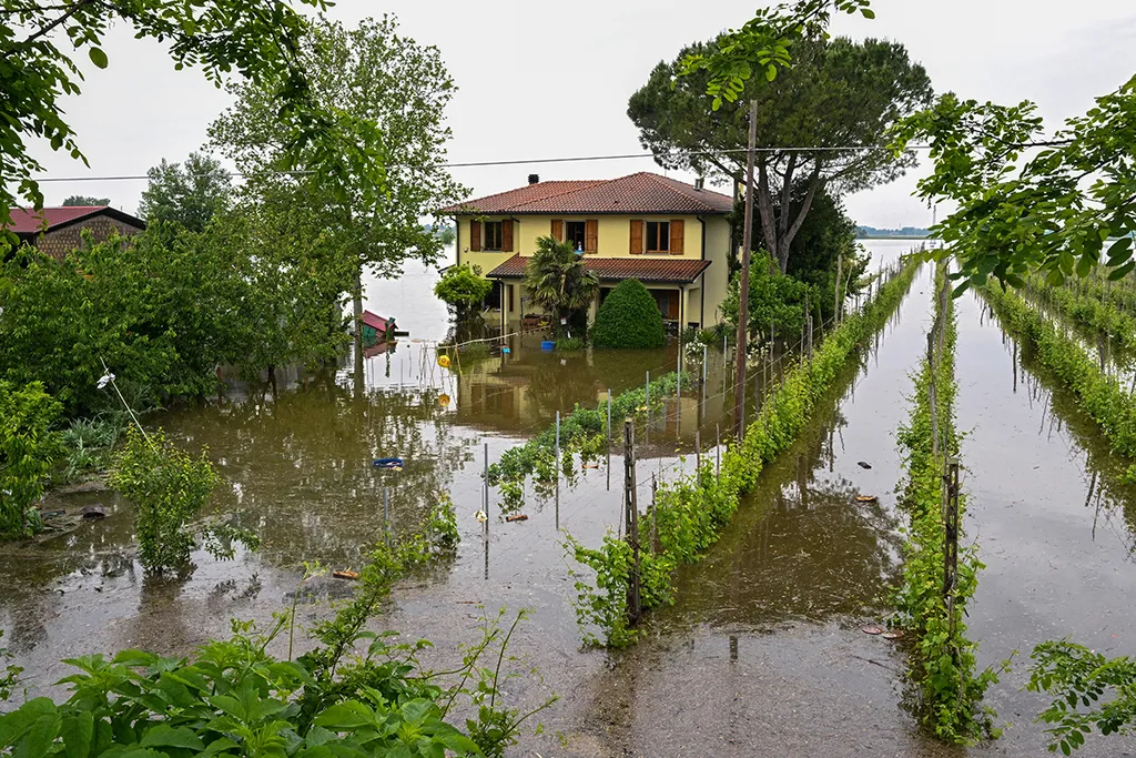 A general view shows a flooded property on May 20, 2023 in the village of Ghibullo, near Ravenna, after floodwaters hit the Emilia-Romagna region. The toll from floods that have devastated Italy's Emilia Romagna region rose to 14 on May 19, amid calls for the government to revive an abandoned project to mitigate the impact of natural disasters. (Photo by Andreas SOLARO / AFP)