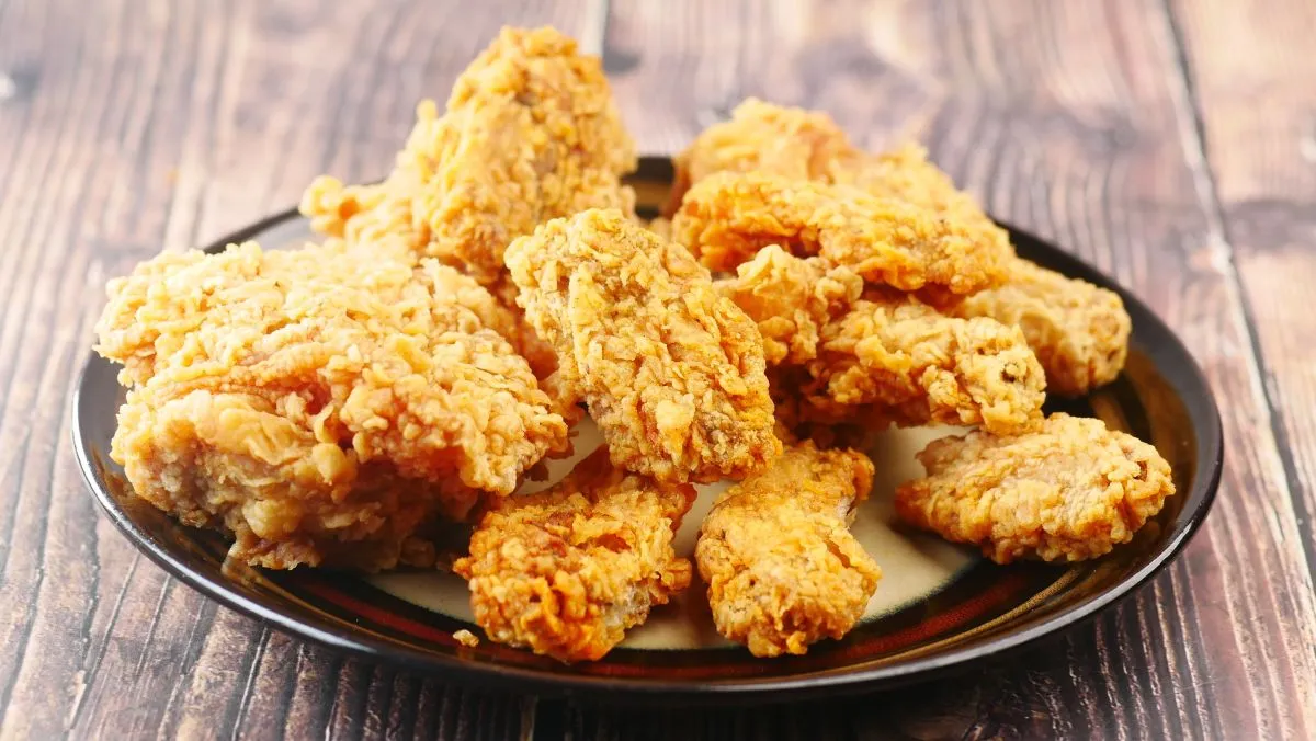 Crispy fried chicken wings on a plate top view .