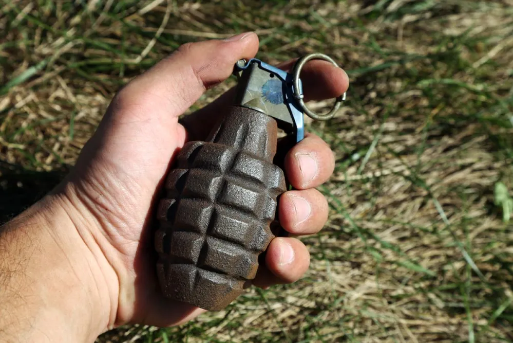 American,Combat,Grenade,In,A,Man's,Hand