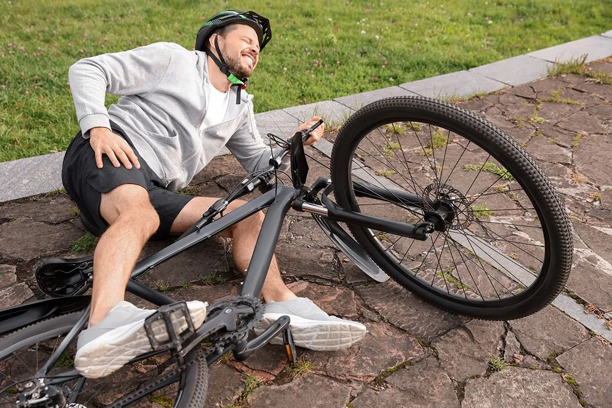 Man,Fallen,Off,His,Bicycle,In,Park