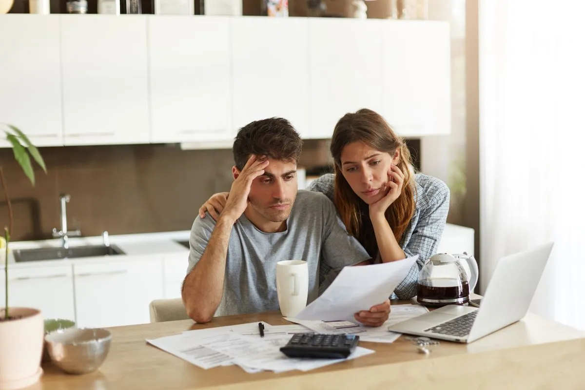 Unhappy,American,Couple,Managing,Home,Accounts,In,Kitchen,,Trying,To
