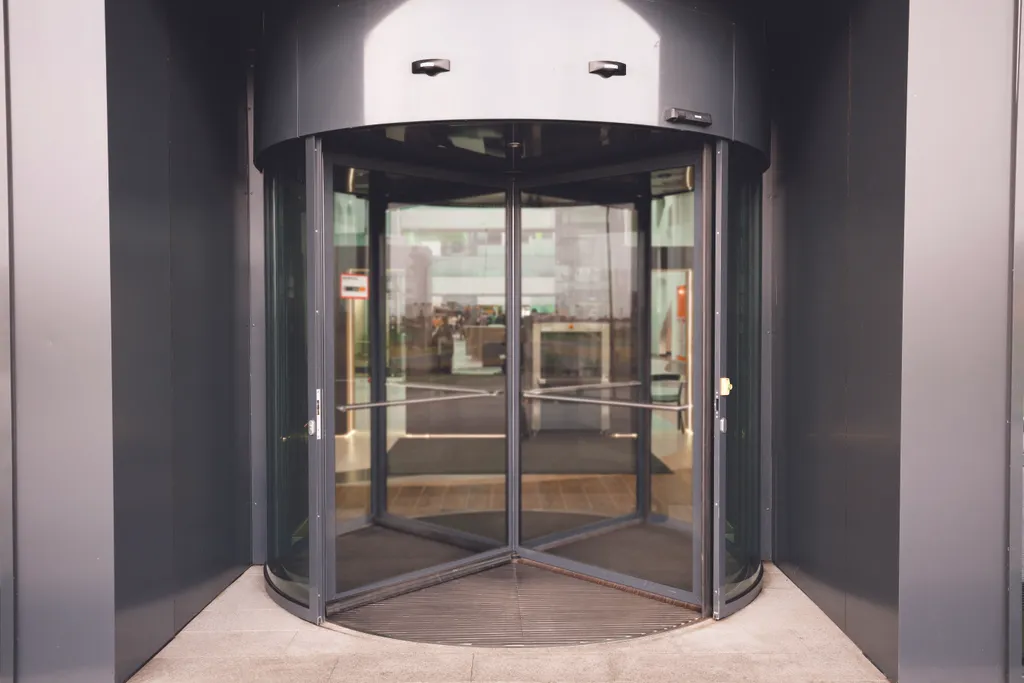 Revolving,Door,In,Reception,Of,Office,Building.