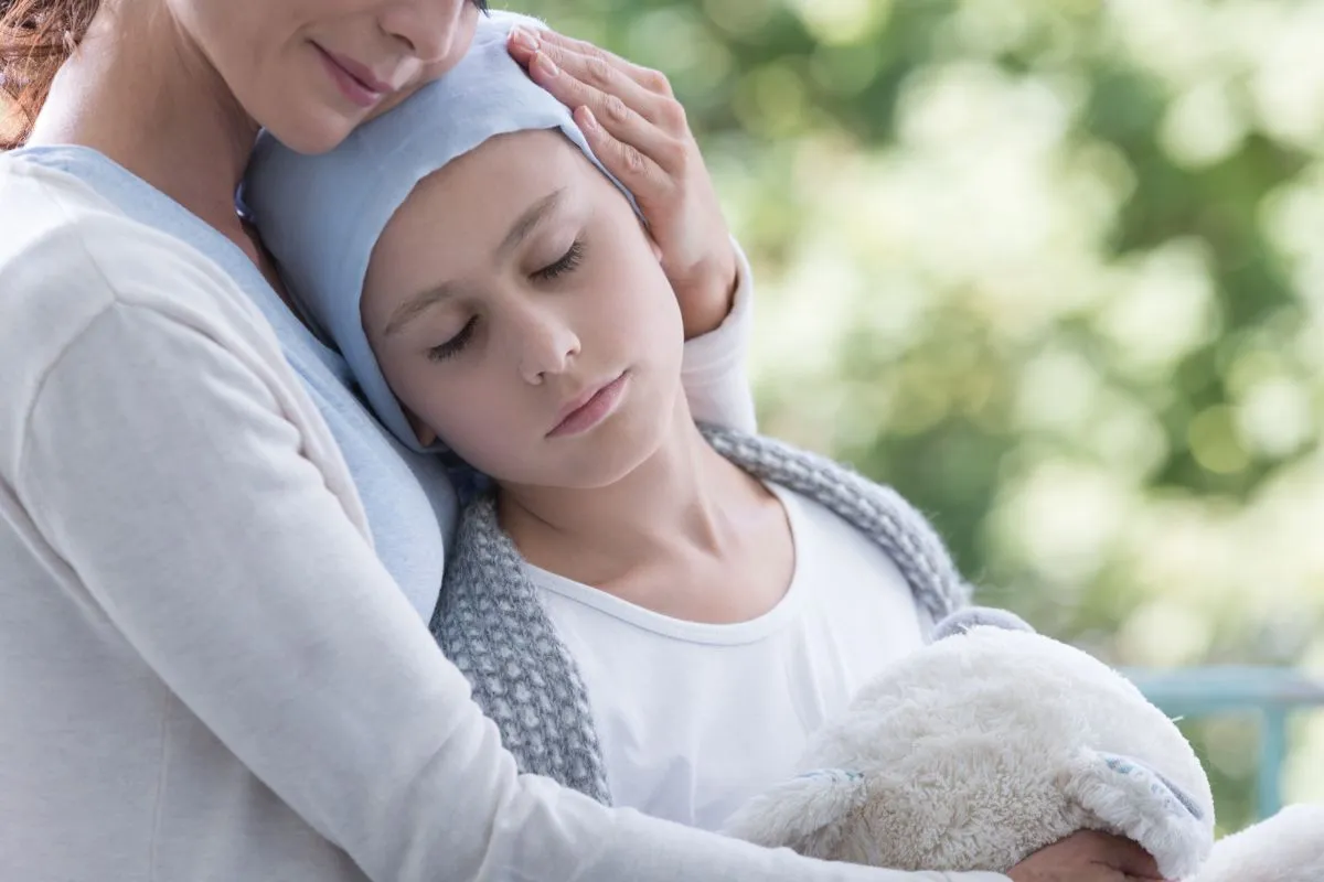 Mother,And,Sick,Teenager,Daughter,With,Cancer,In,The,Garden