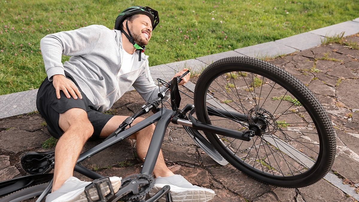 Man,Fallen,Off,His,Bicycle,In,Park