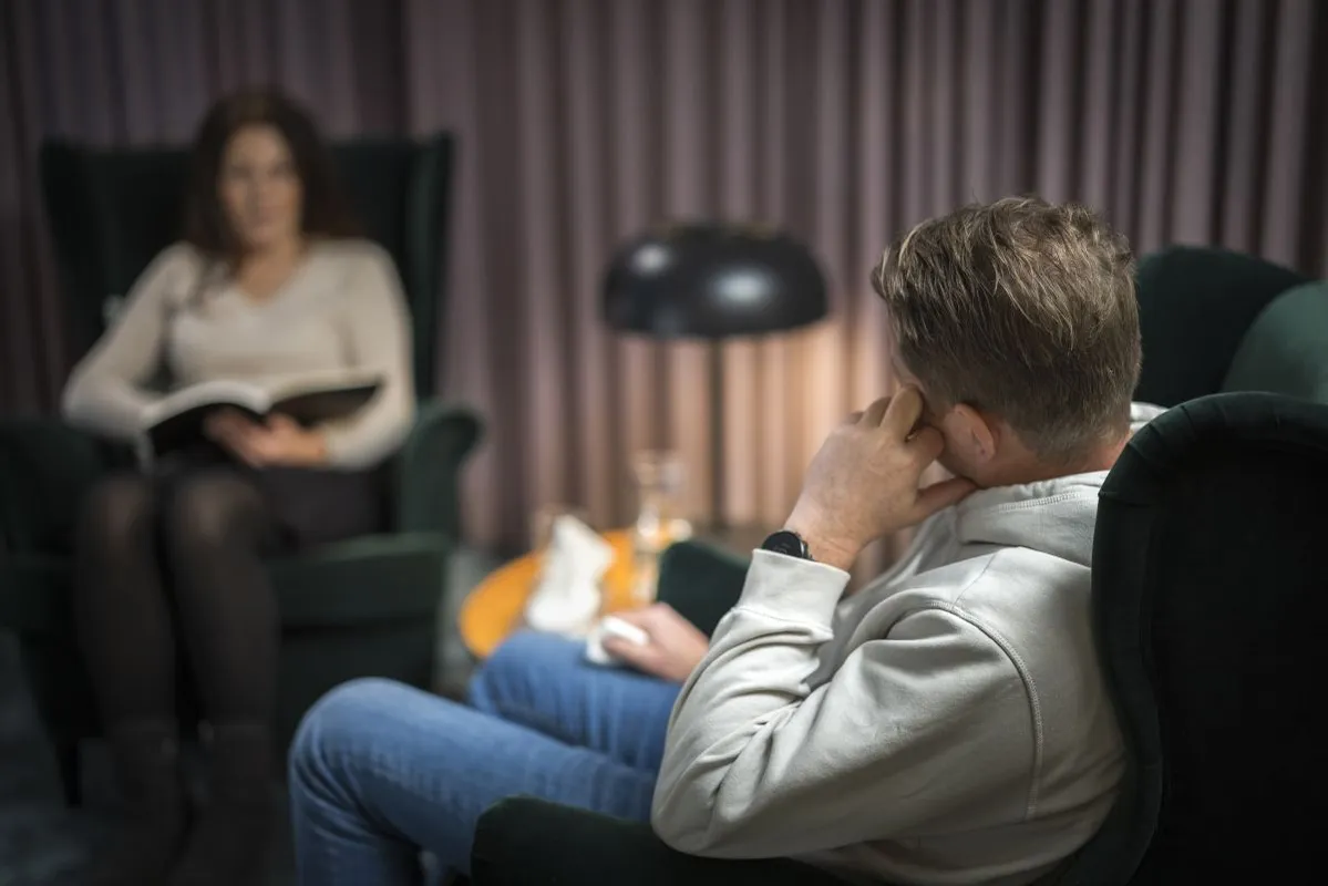 Male patient and female doctor at therapy session