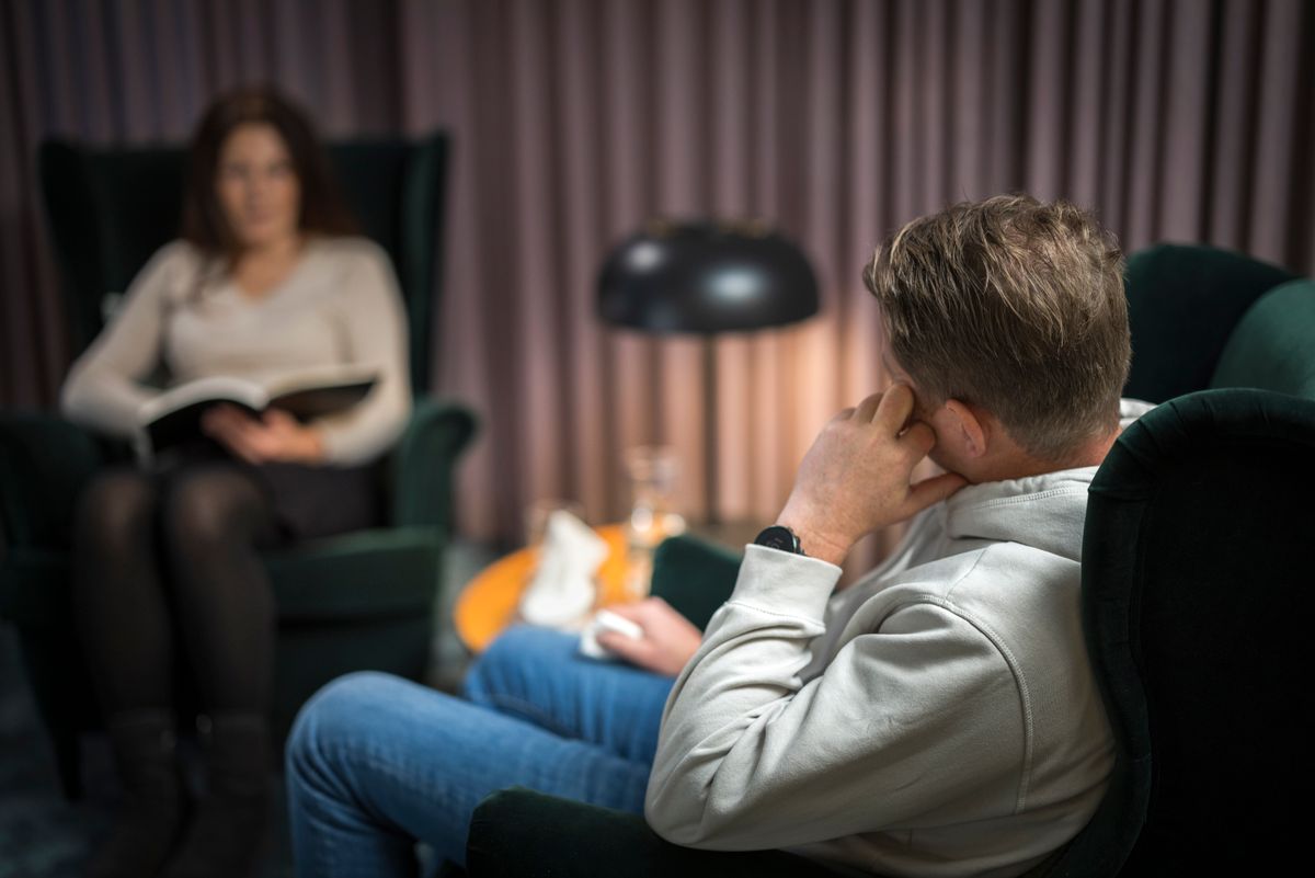 Male patient and female doctor at therapy session