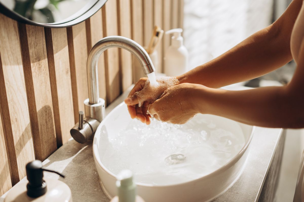 Woman,Carefully,Washing,Her,Hands,With,Soap,And,Water,In