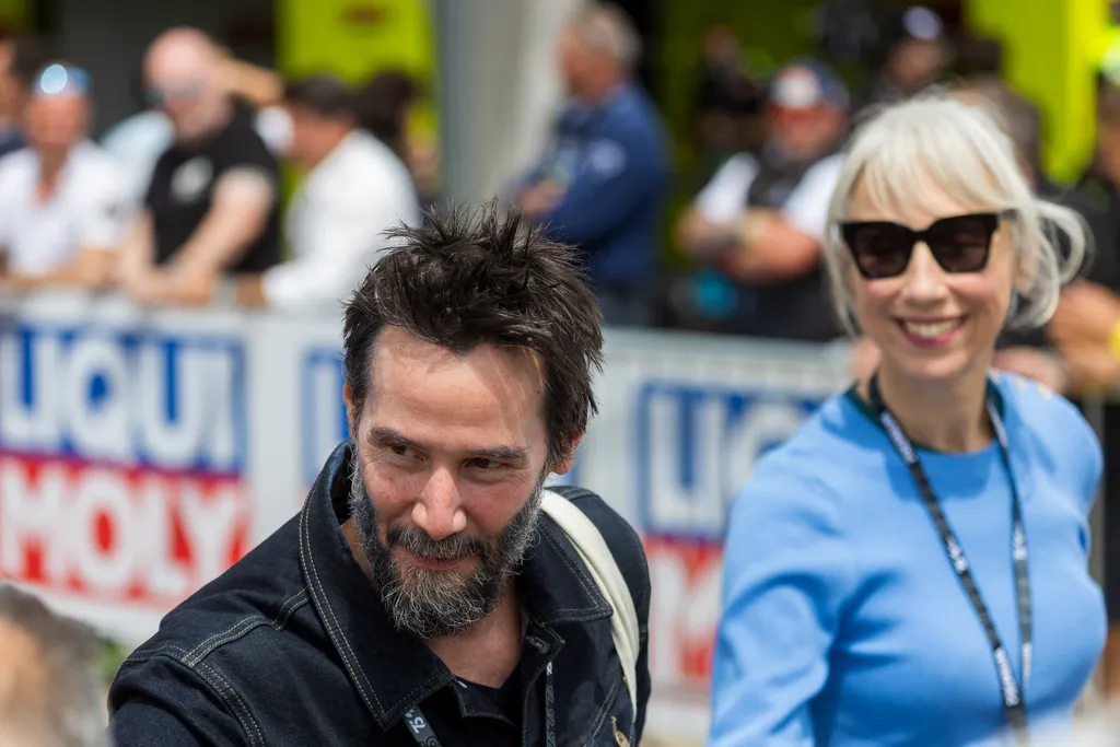 Canadian actor Keanu Reeves and partner Alexandra Grant attend the German Motorcycle Grand Prix at the Sachsenring racetrack in Hohenstein-Ernstthal, eastern Germany, on July 7, 2024. (Photo by Radek Mica / AFP)