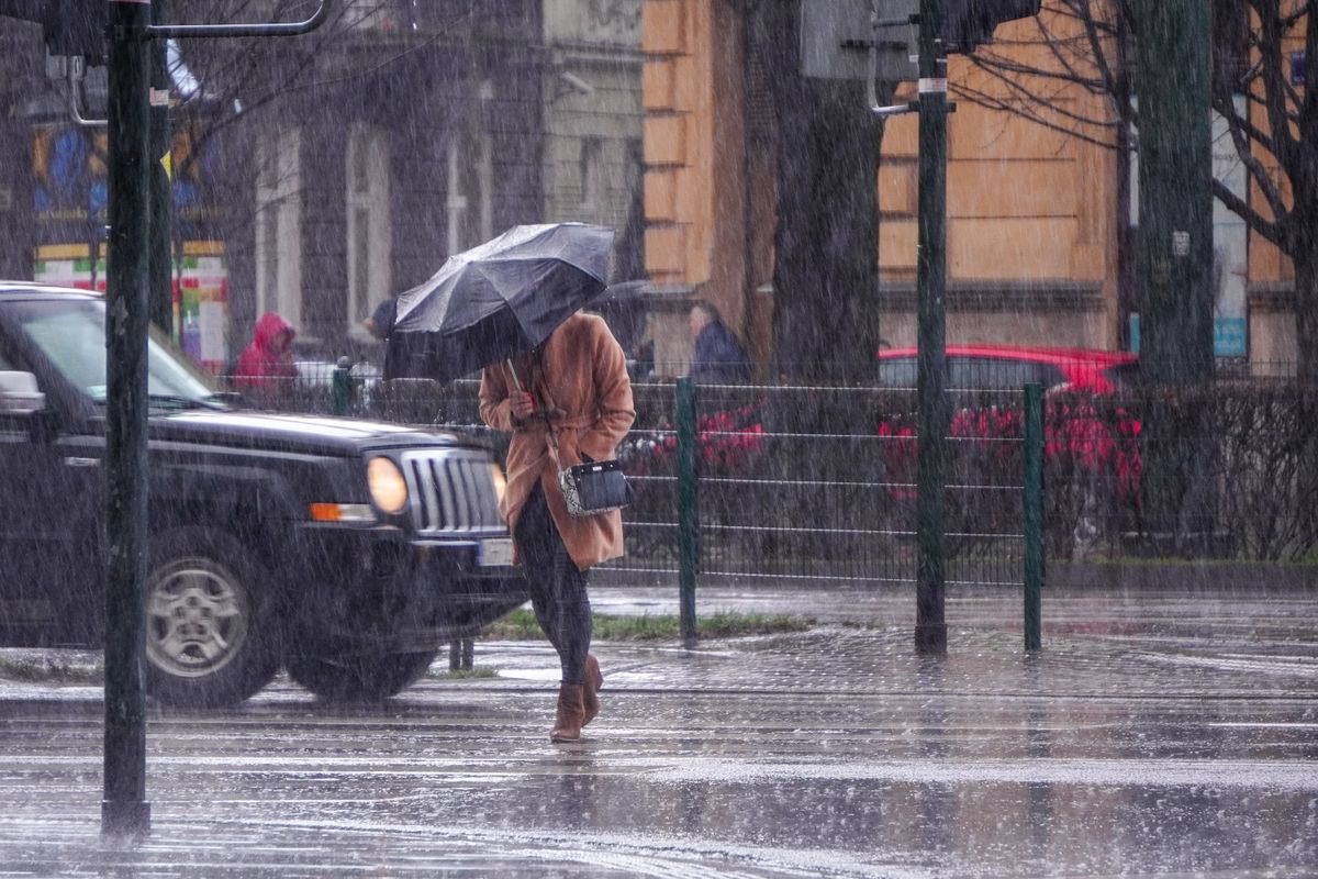 A,Woman,In,A,Brown,Coat,Under,An,Umbrella,Crosses