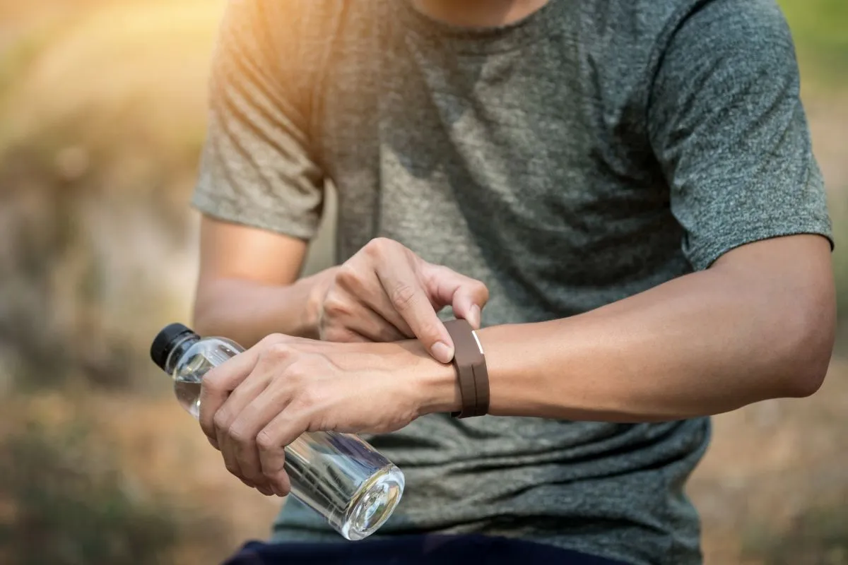 Young,Man,Checking,Time,On,His,Sports,Watch.