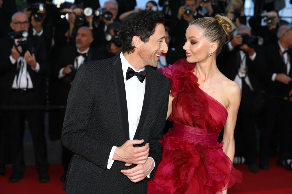 ADRIEN BRODY and REBECCA ZLOTOWSKI pose on the red carpet for the 'A Private Life' Premiere screening at the 78th Annual Cannes Film Festival at Palais des Festivals in Cannes, France