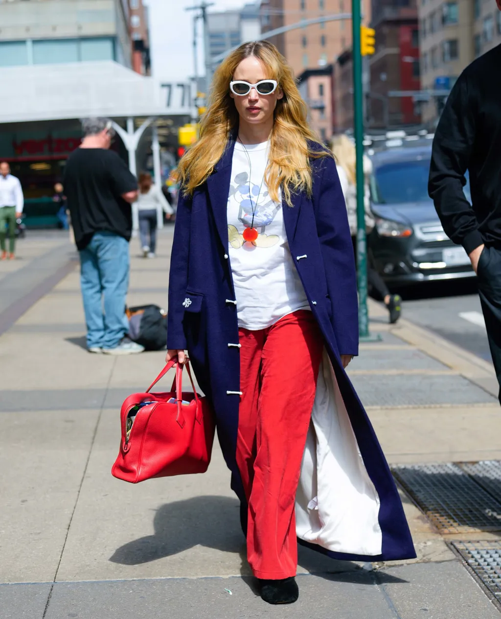 03/31/2025 EXCLUSIVE: Jennifer Lawrence and Cooke Maroney step out together in New York City. The American actress carried a red hermes bag and wore a blue trench coat, vintage Mickey Mouse t-shirt, red trousers, and black flats.

sales@theimagedirect.c