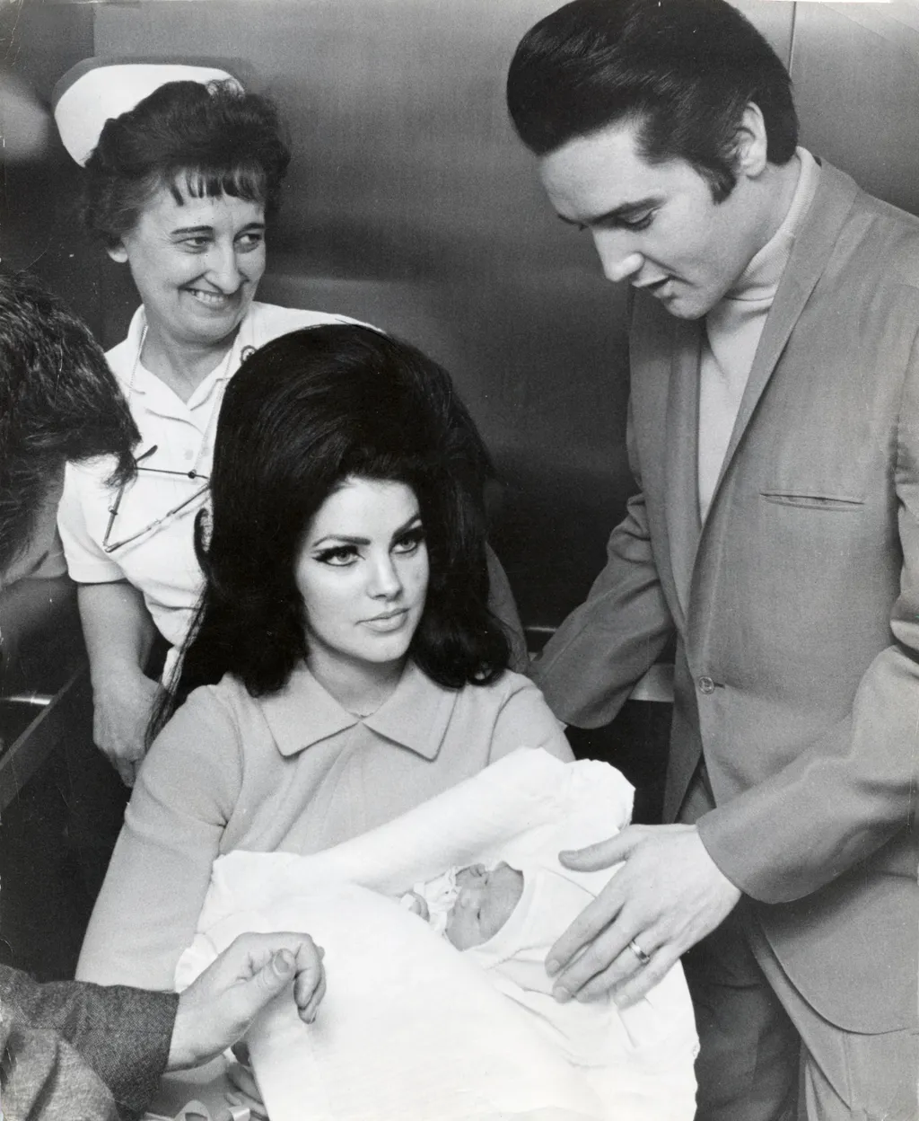 Feb. 10, 1968 - Memphis, TN, U.S. - The undisputed King of Rock 'n' Roll, ELVIS PRESLEY, pictured with his wife PRISCILLA BEAULIEU and his newborn daughter Lisa Marie leaving Baptist Hospital. A white southerner who singing blues laced with country and co