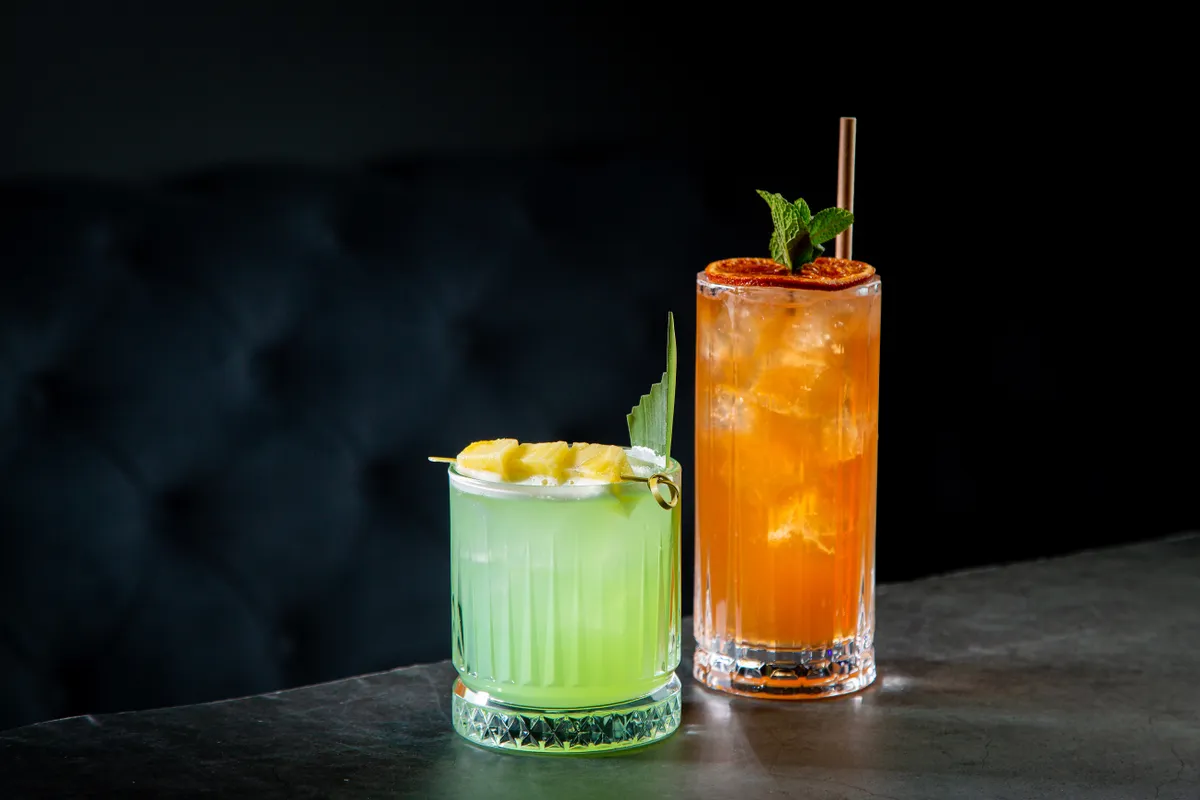 Lime,Coctail,With,Pineapple,Pieces,And,Cinnamon,Side,View