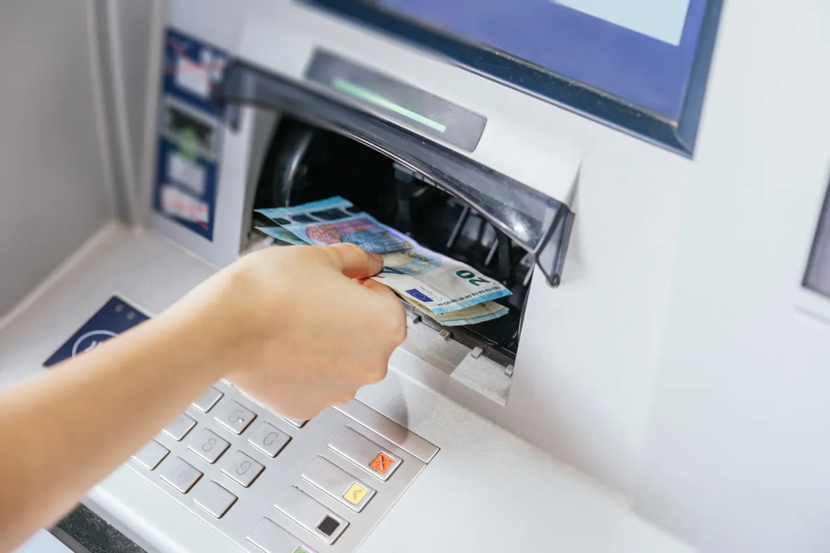 Close,Up,Of,A,Woman's,Hand,Withdrawing,Cash,,Euro,Bills