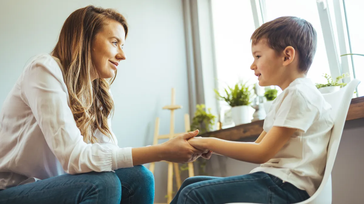 Young,Boy,Talking,With,Counselor,At,Home.,Female,Psychologist,Working