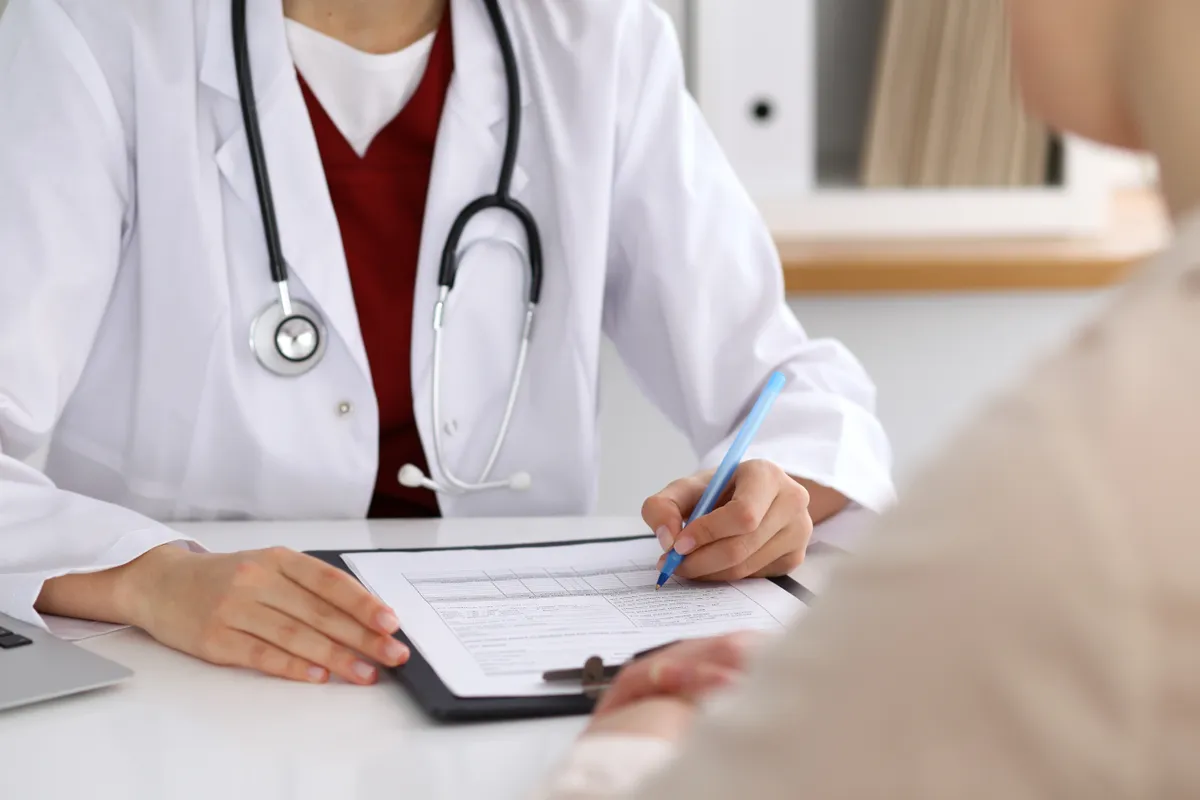 Close,Up,Of,A,Female,Doctor,Filling,Up,An,Application