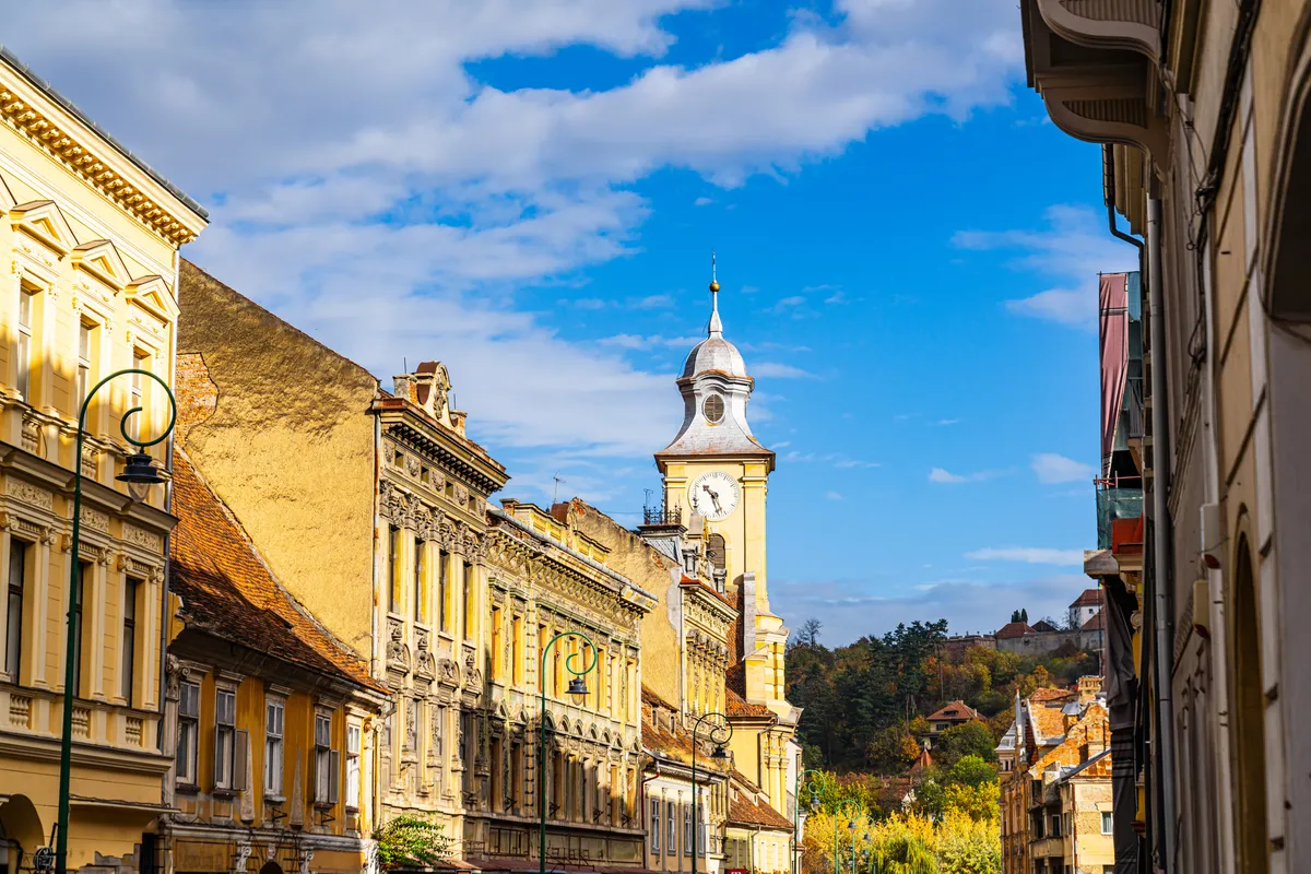 Bra?ov's,Historic,Street,With,Clock,Tower.,A,Charming,Street,In