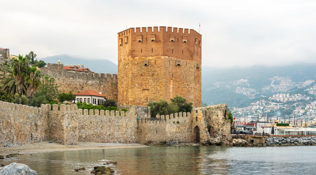 Alanya látképét a XIII. századi szeldzsuk erőd és az ikonikus téglavörös torony uralja – a falakról lélegzetelállító panoráma nyílik a Földközi-tengerre.