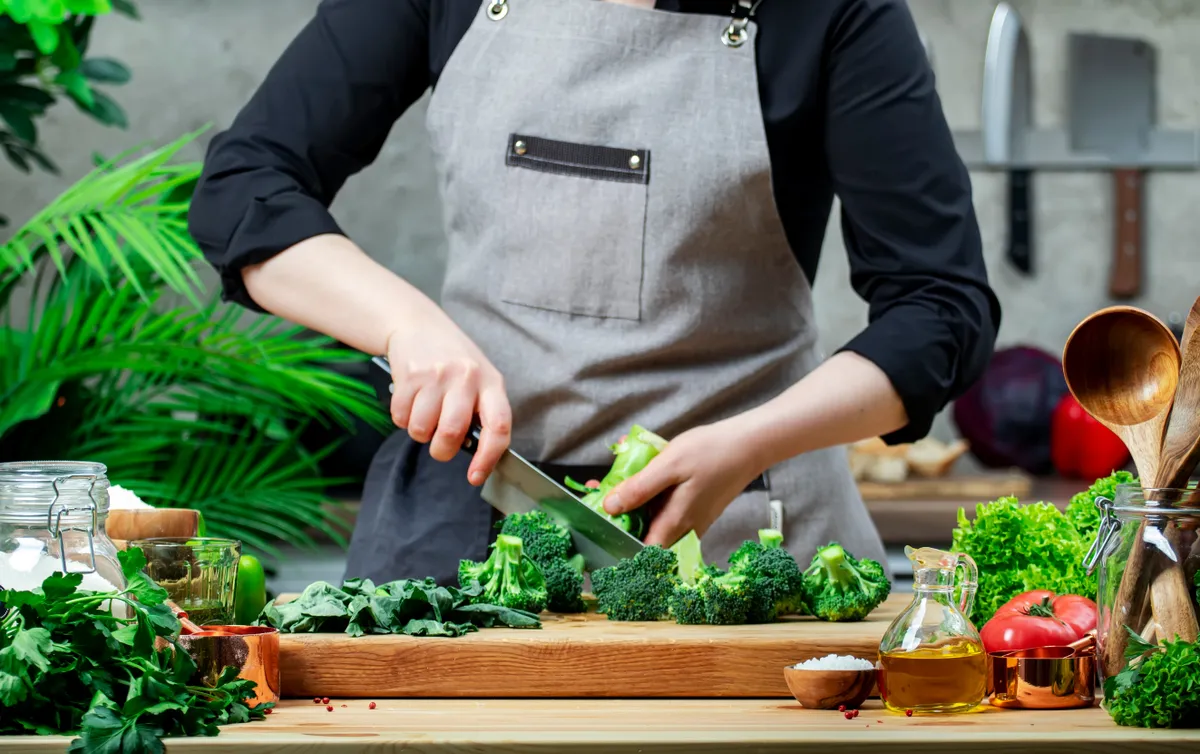 Cook,Cutting,Broccoli,Florets,With,Knife.,Cozy,Kitchen,With,Wooden