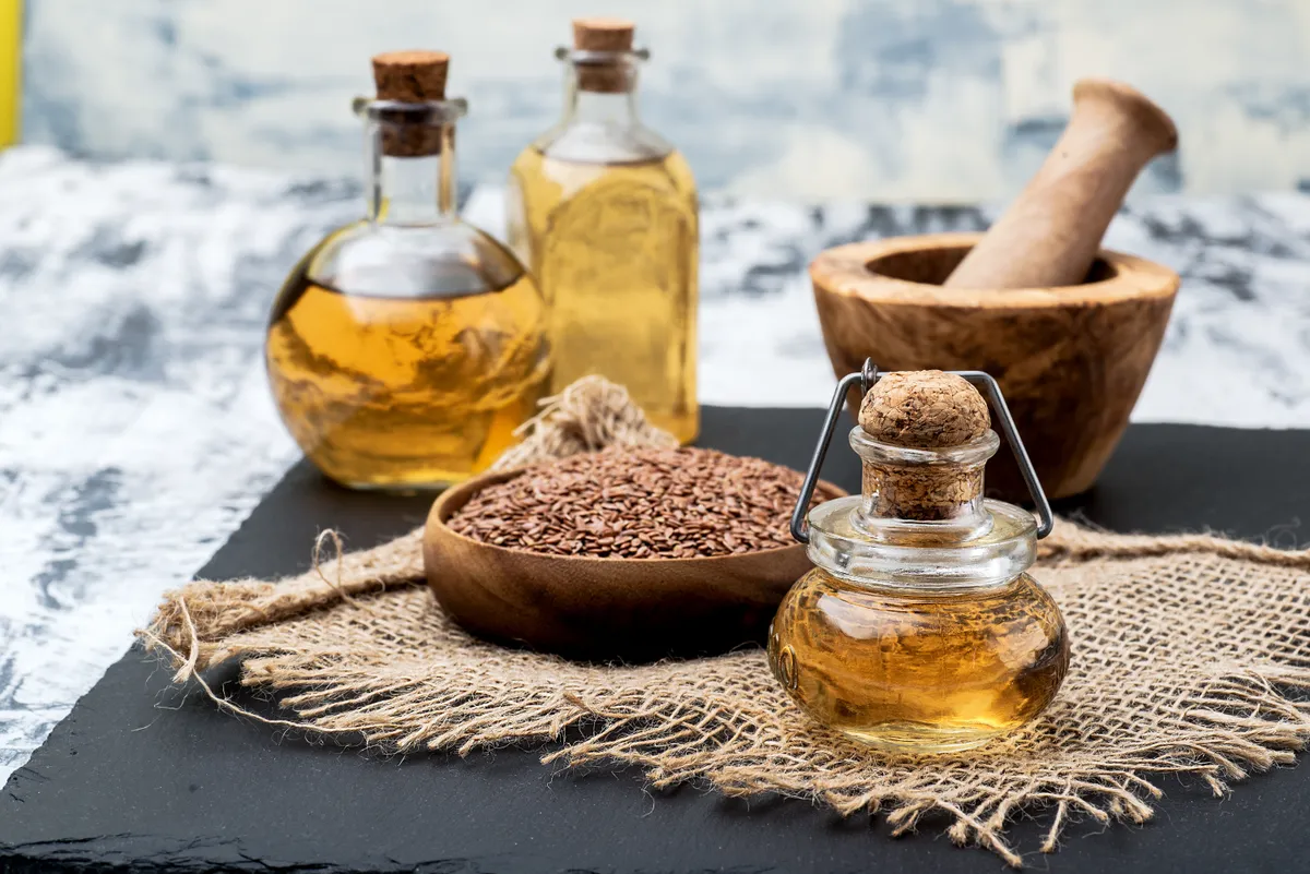 Bowl,Of,Flax,Seeds,And,A,Bottle,Of,Fresh,Linseed