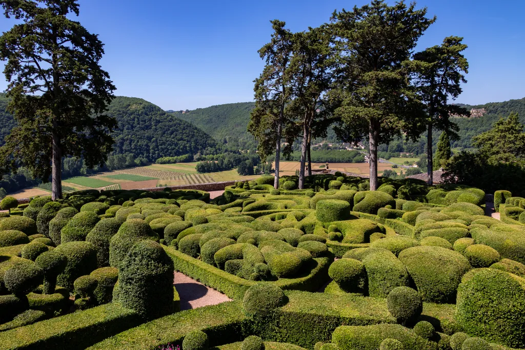 A franciaországi Marqueyssac kertek a Dordogne folyó fölött kanyargó, hullámzó bukszusbokraikról híresek, melyek naplementében egészen valószerűtlen látványt nyújtanak.