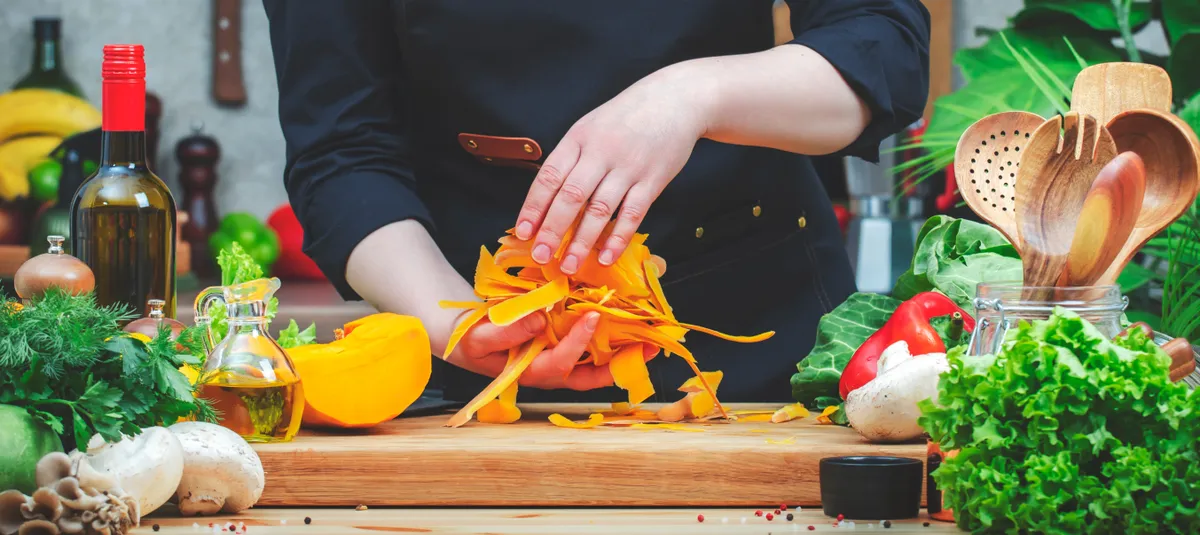 Sütőtök héjat a kezében tartó nő