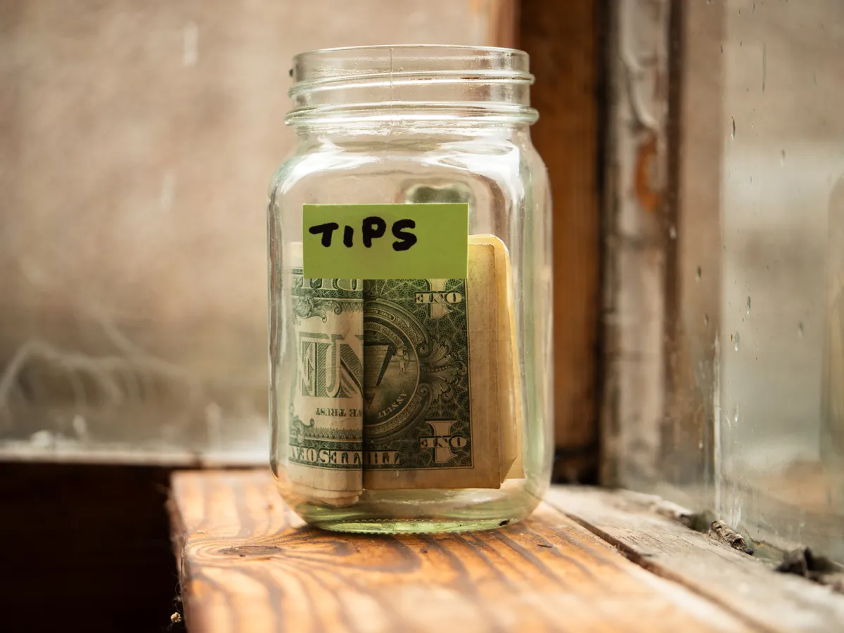 Egy befőtes üveg borravalónak, amiben dollárok vannak.