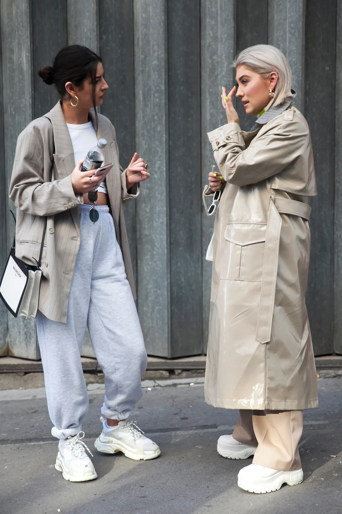 Fiatal nők melegítőnadrágban és elegáns kabátban