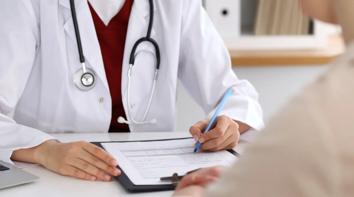 Close,Up,Of,A,Female,Doctor,Filling,Up,An,Application