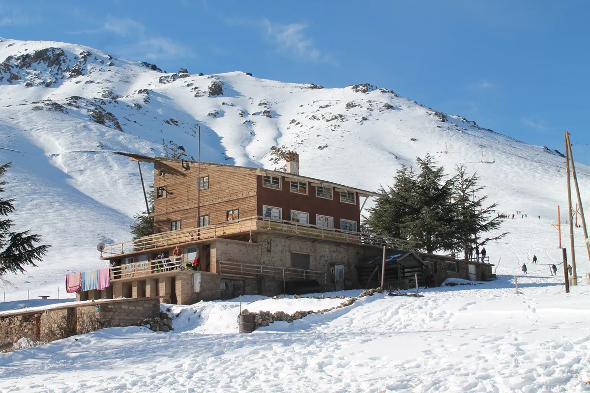 Ház a marokkói Oukaimeden síterepén havas környezetben.