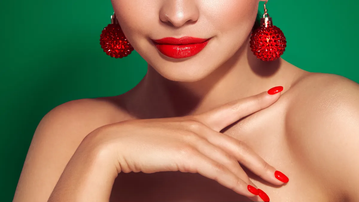 Piros rúzs és karácsonyi smink egy szép fiatal nő arcán.