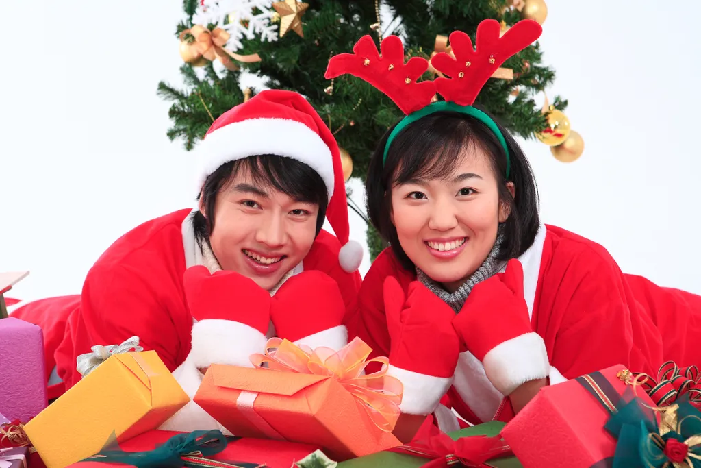 Asian couple with santa outfit - isolated on white