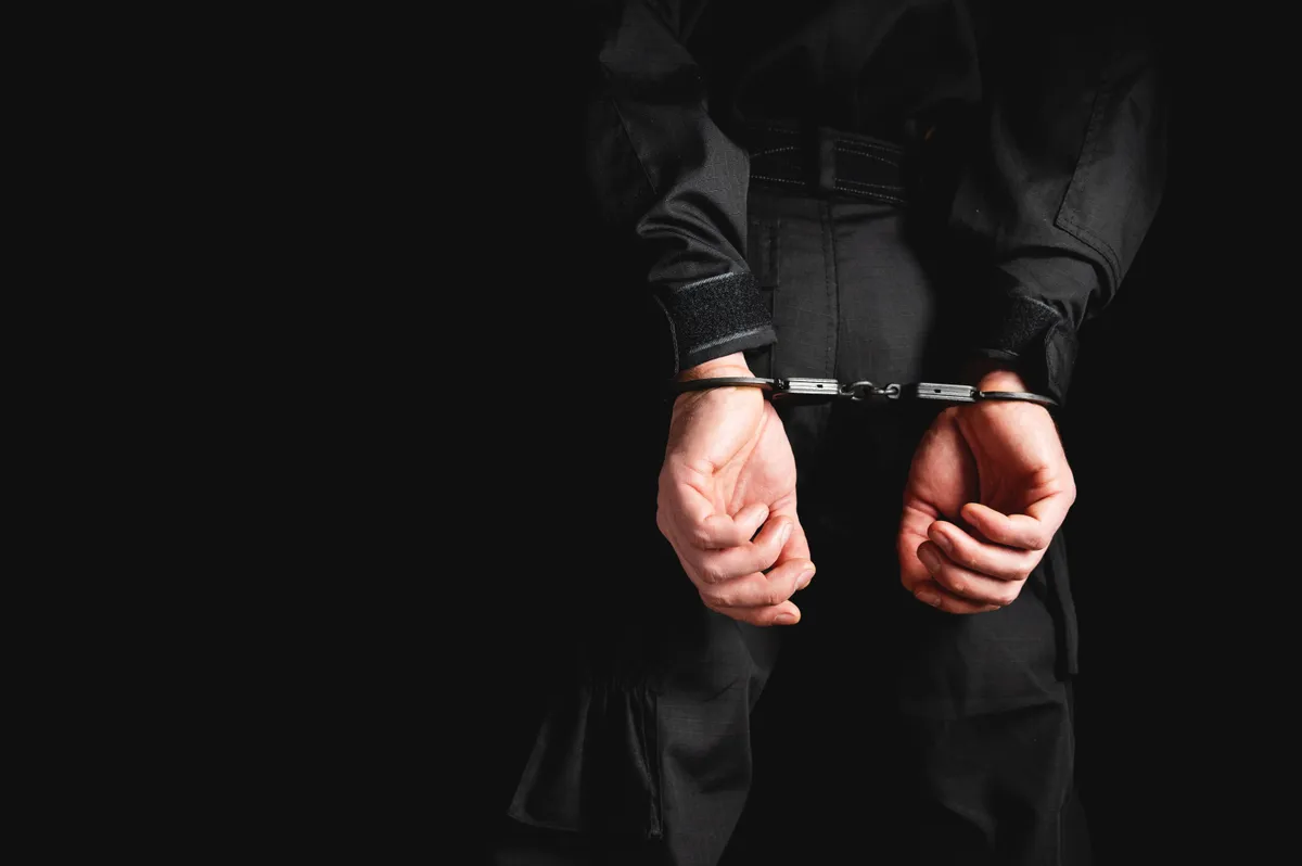 Man,In,Uniform,Hands,In,Steel,Handcuffs.,Corruption,In,Law